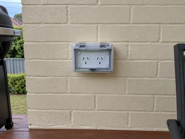 Outdoor double power point on painted brick wall beside a patio in Broadmeadow